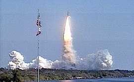 Launch of U.S. Space Shuttle Endeavour Launch Feb. 11, 2000, Seen Beyond American Flag